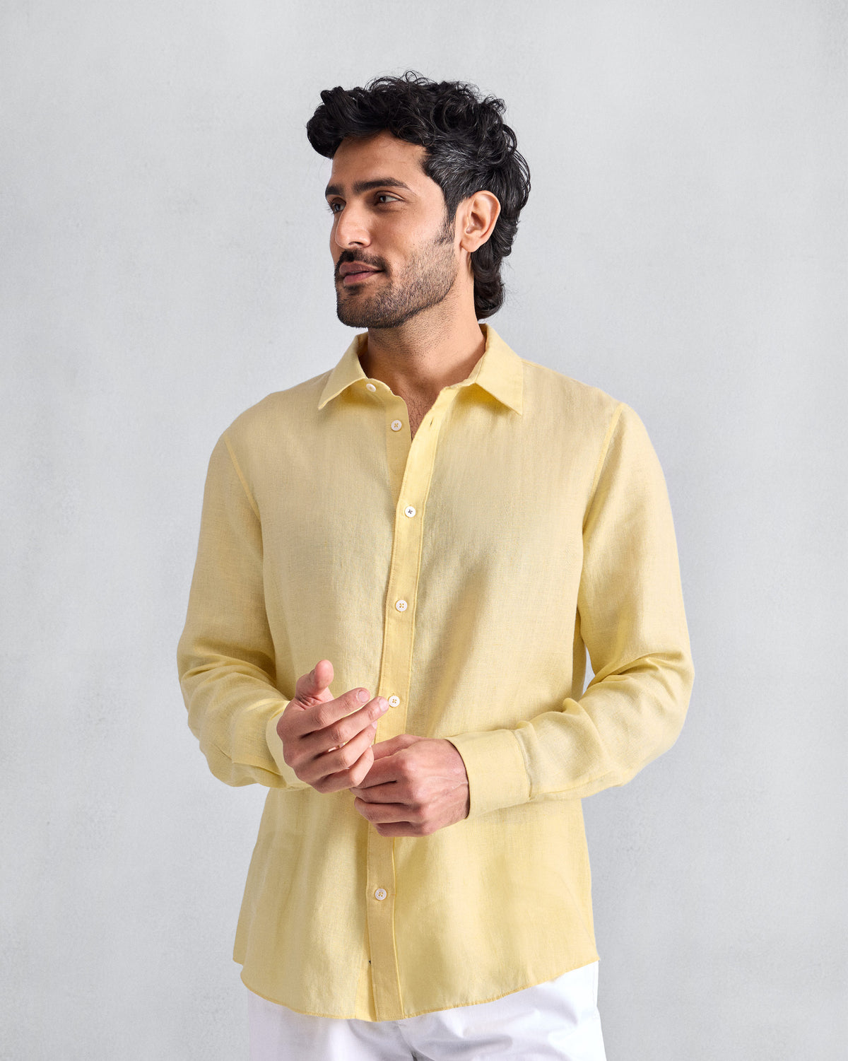 Person wearing a lemon Classic shirt untucked.