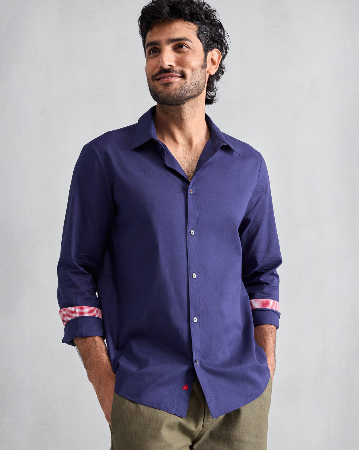 Person wearing an ink blue Classic shirt with pink cuff lining.