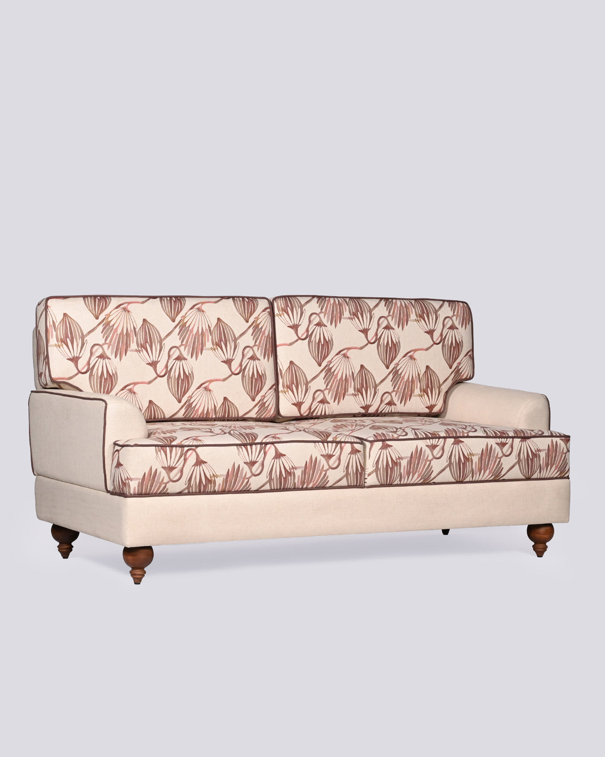 Field Sofa with terracotta botanical cushions edged in dark brown piping.