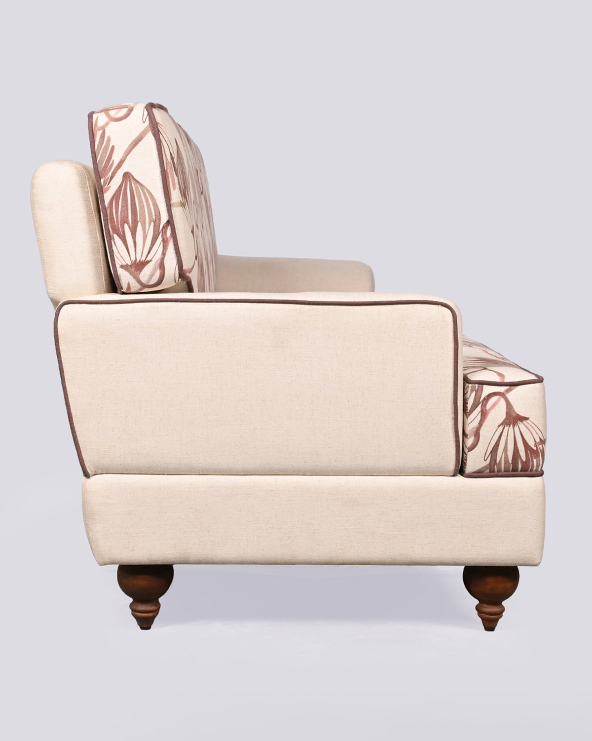 Side view of the Field Sofa with a cream arm and turned wood leg.