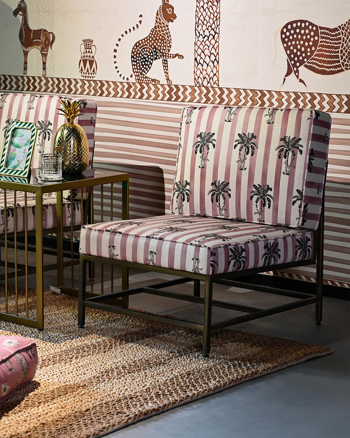 Bay Chair with palm-print striped cushions styled in a mural-lined room.