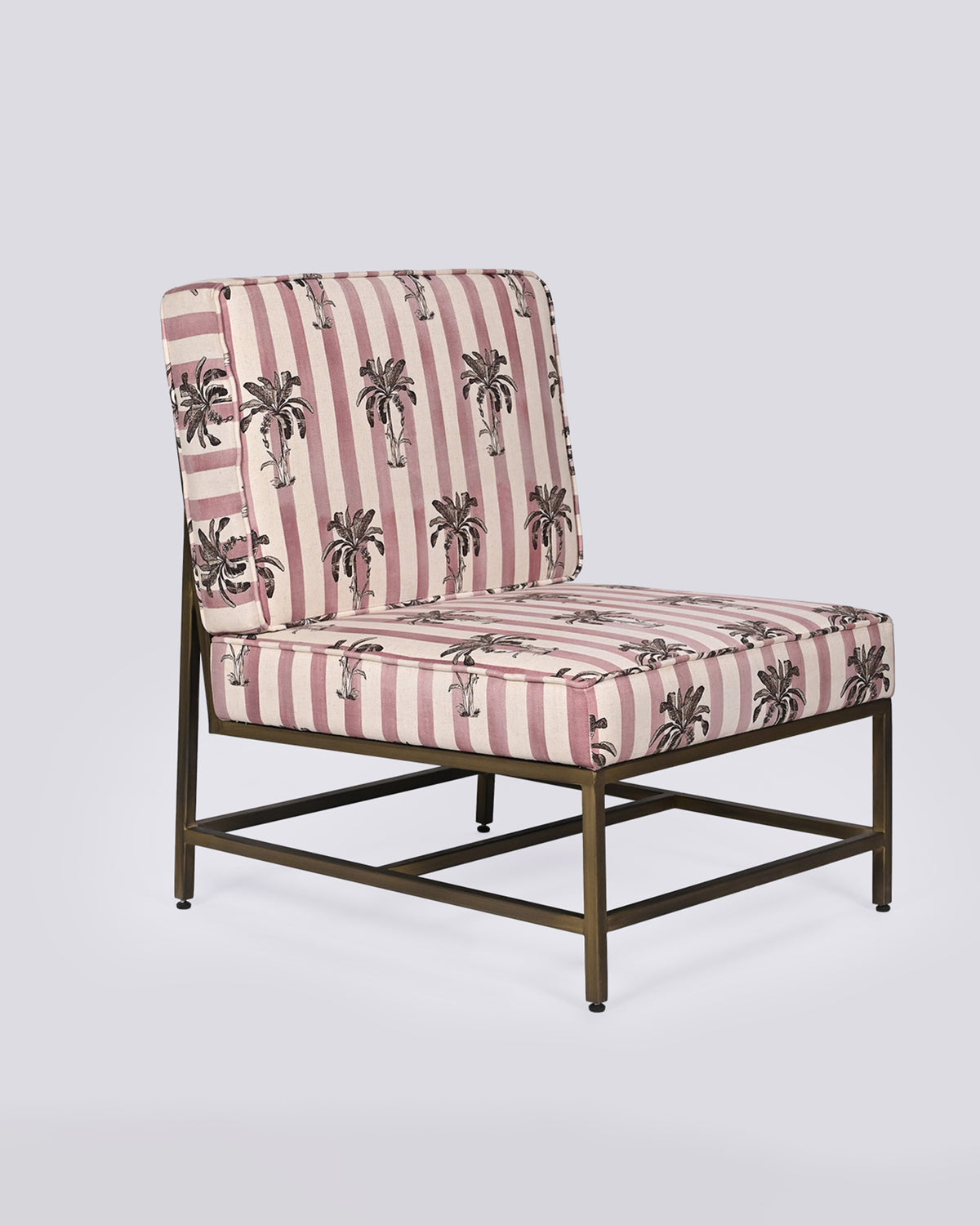 Three-quarter view of a Bay Chair with palm-print stripes on a brass frame.