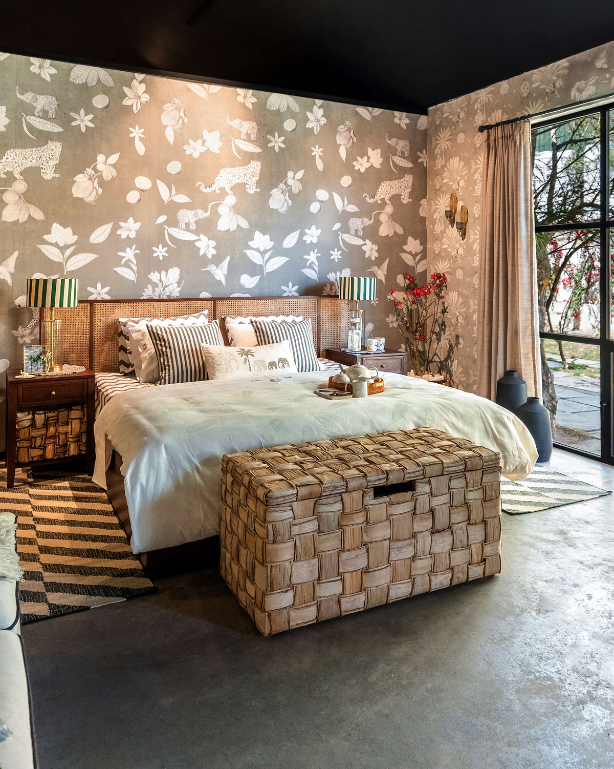 Solstice bed with cane headboard centered in a styled bedroom.