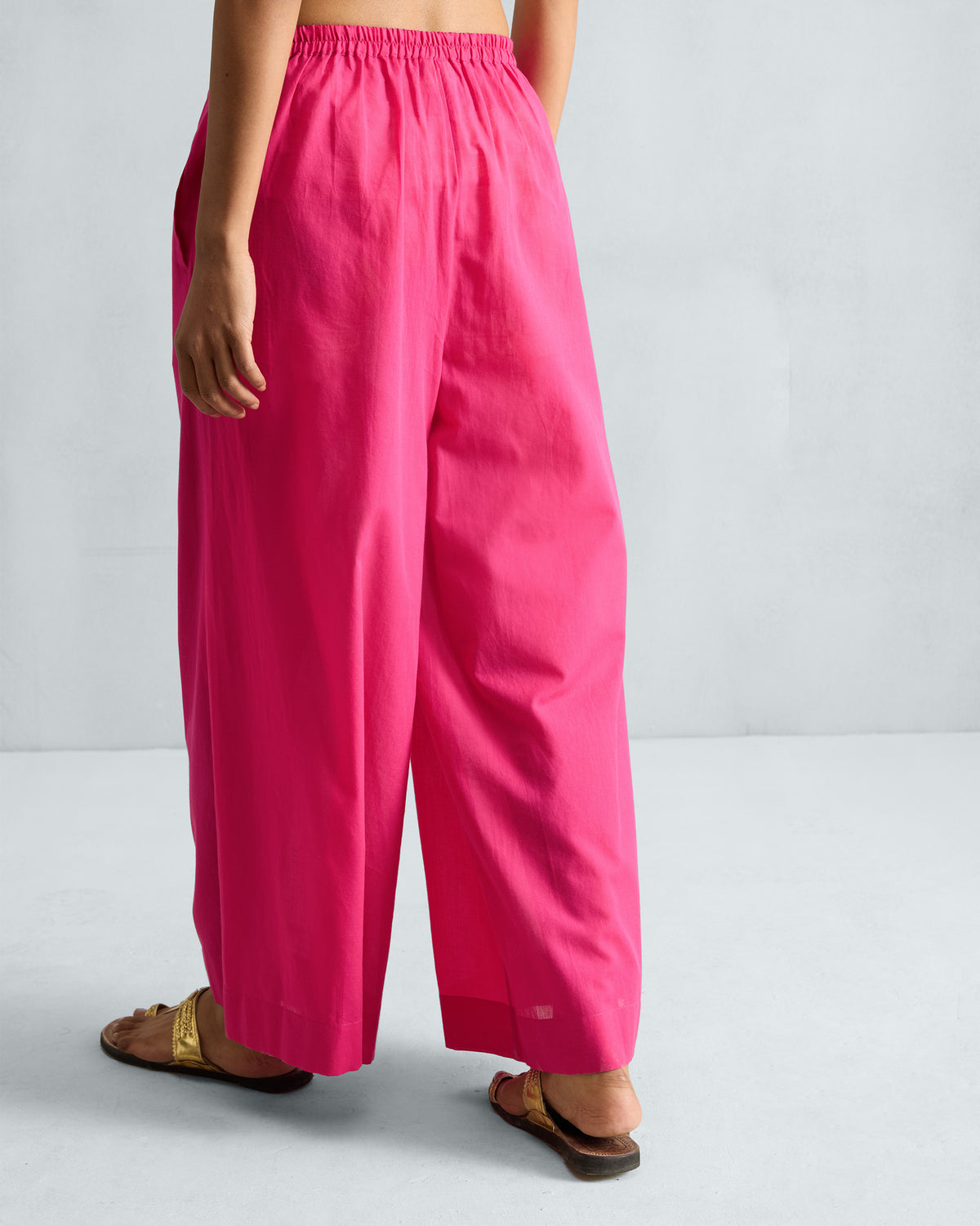 Back of fuchsia Basic Pyjamas with an elastic waistband worn by a person.