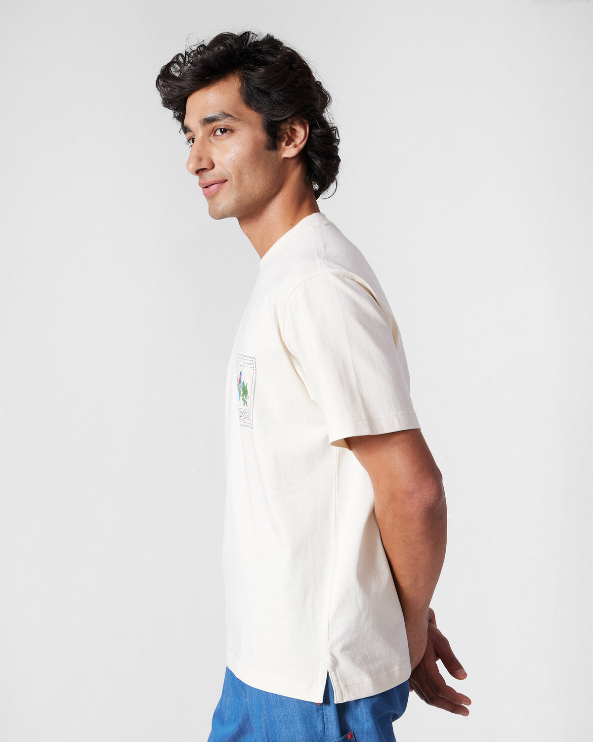Side view of an ivory Bulbul t-shirt with a chest stamp graphic.