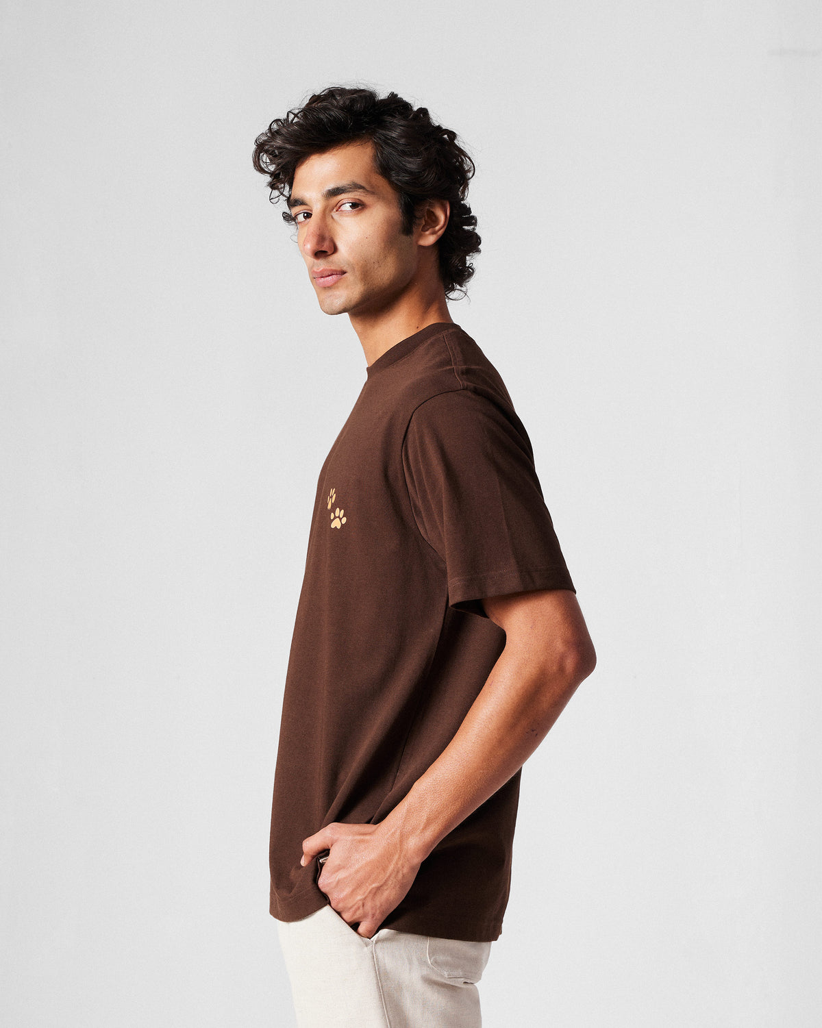 Side view of a brown Leap t-shirt.