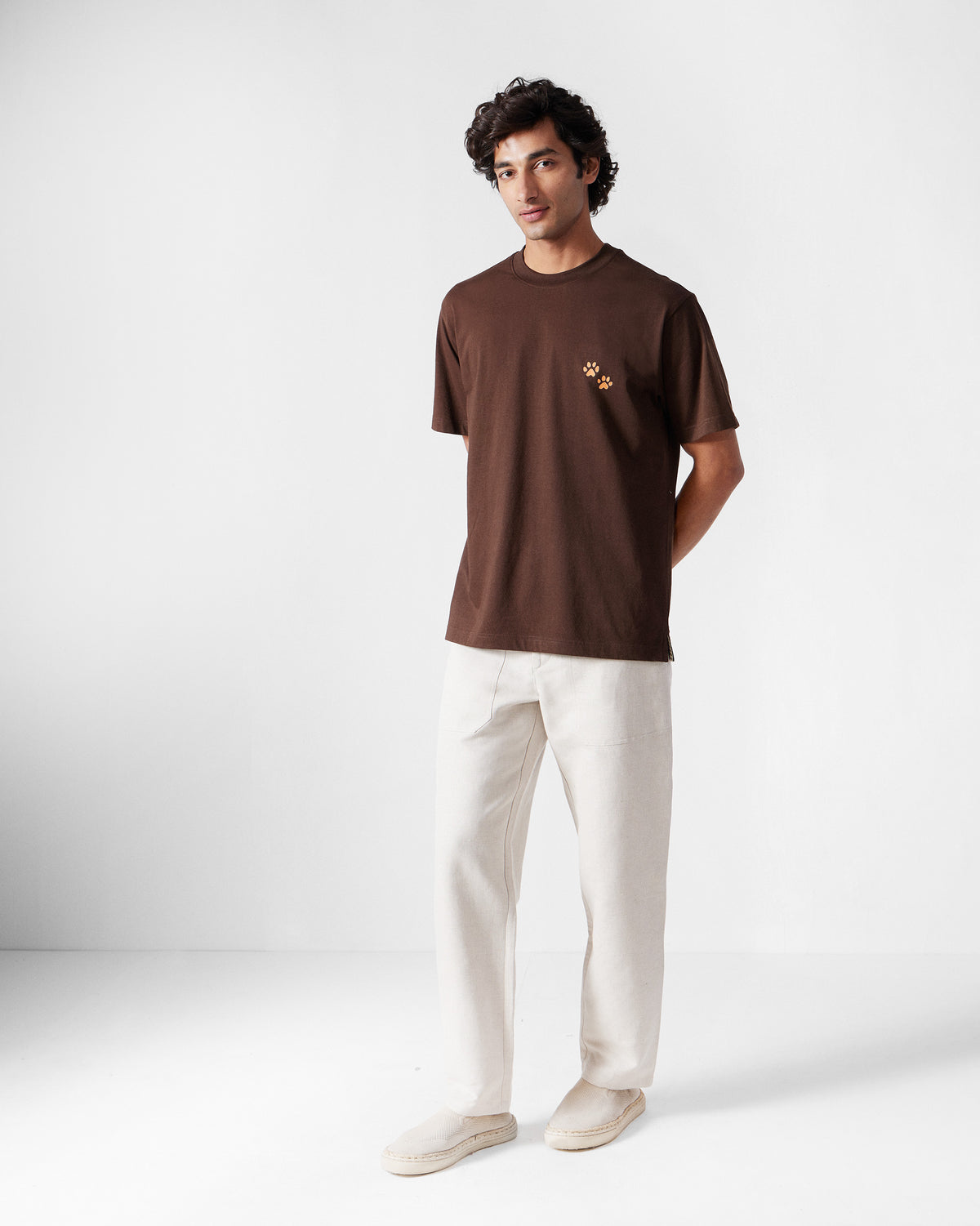 Person wearing a brown Leap t-shirt with peach paw prints.