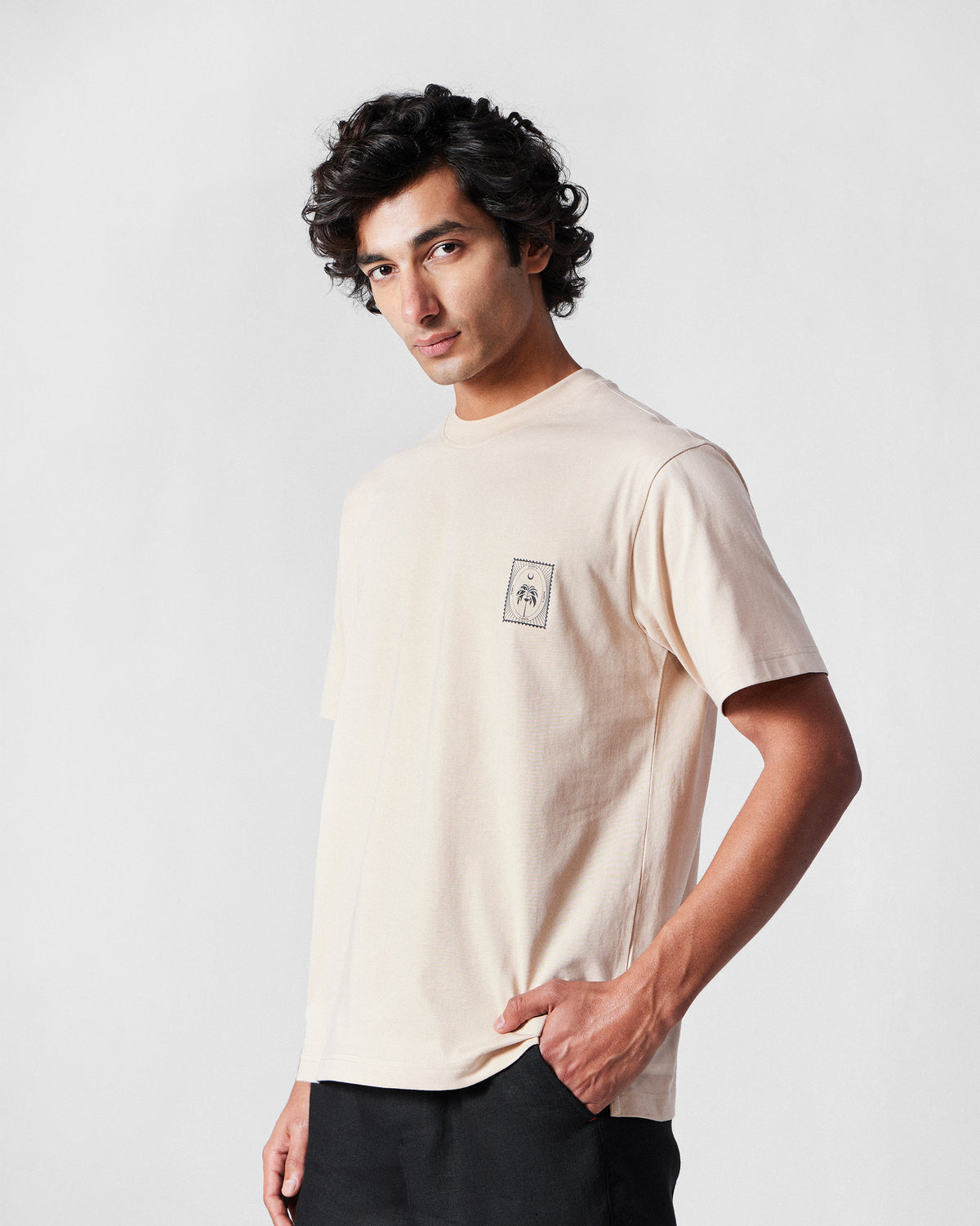 Beige Postal T-Shirt with a small palm stamp on the chest.