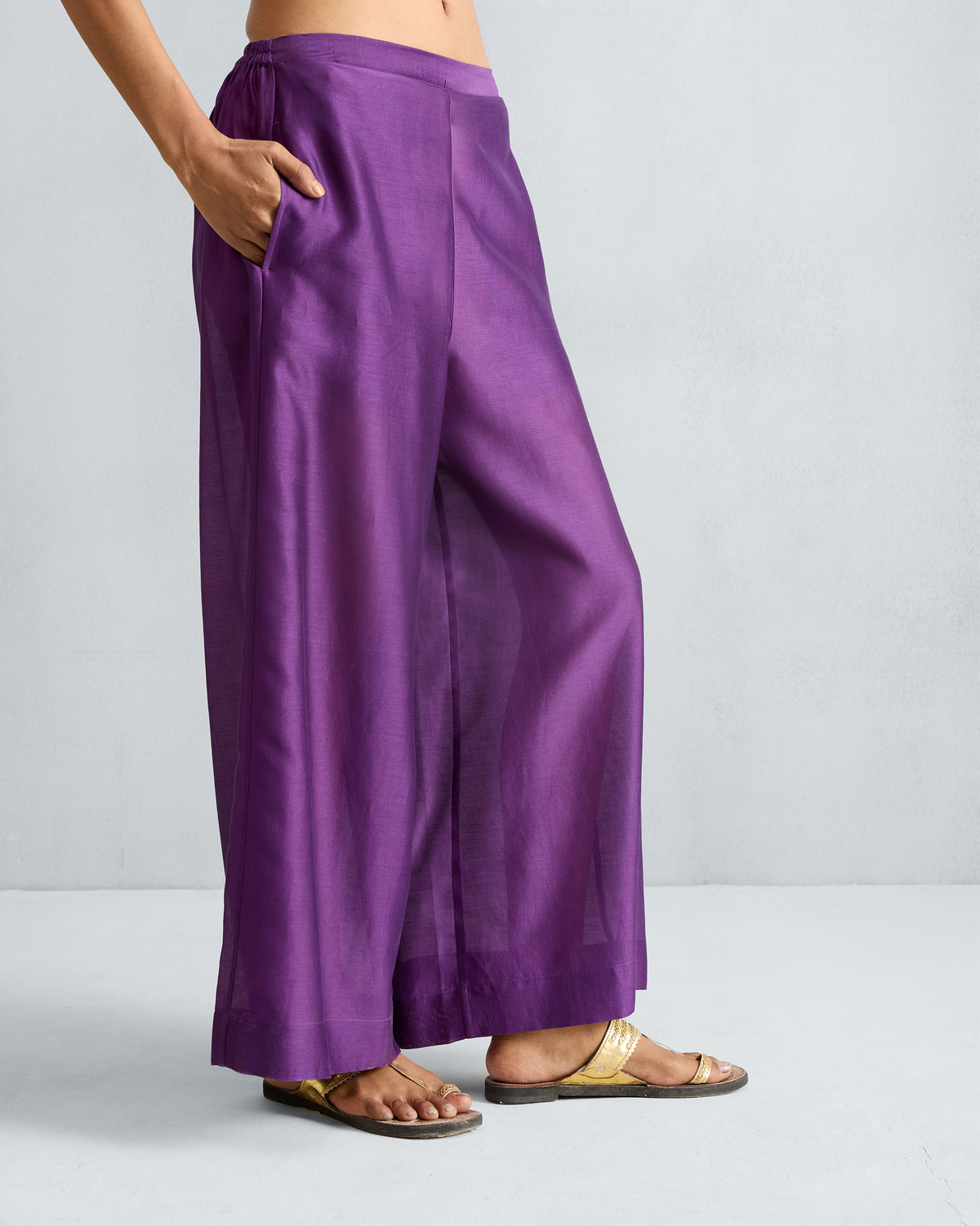 Side view of purple Basic Pyjamas with a hand in the pocket.