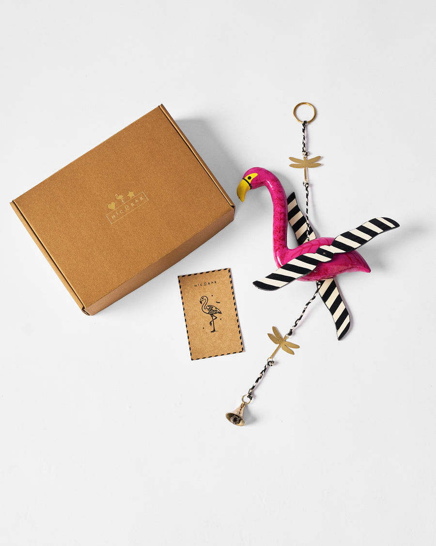The chime beside its kraft gift box.