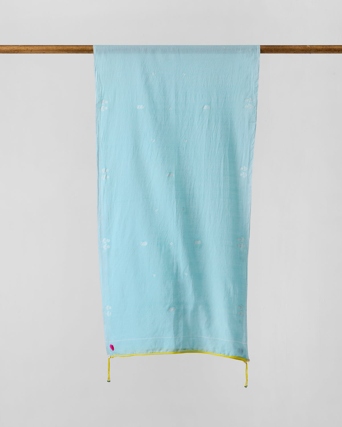 Sky Jamdani scarf hung flat, showing aqua fabric with faint white motifs.