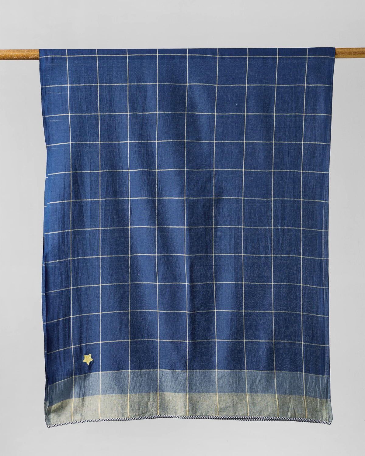 Windowpane Checks scarf hung flat, showing pale check lines on dark blue.
