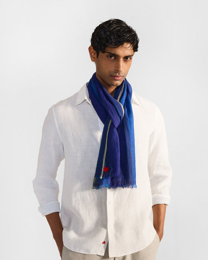 Person wearing a dark blue Everyday Stripes scarf draped at the neck.