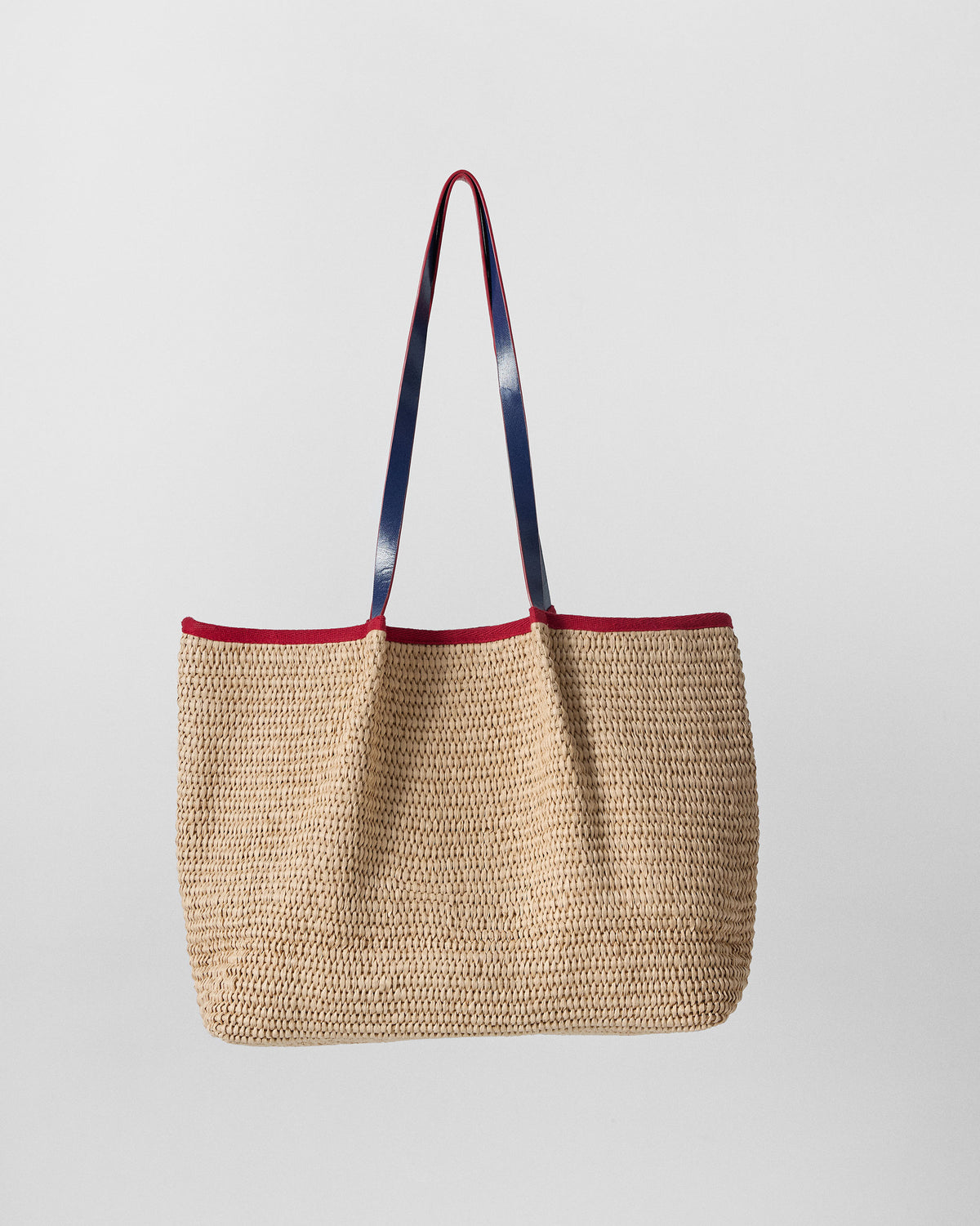Natural Dil Woven Tote with red and navy leather straps.