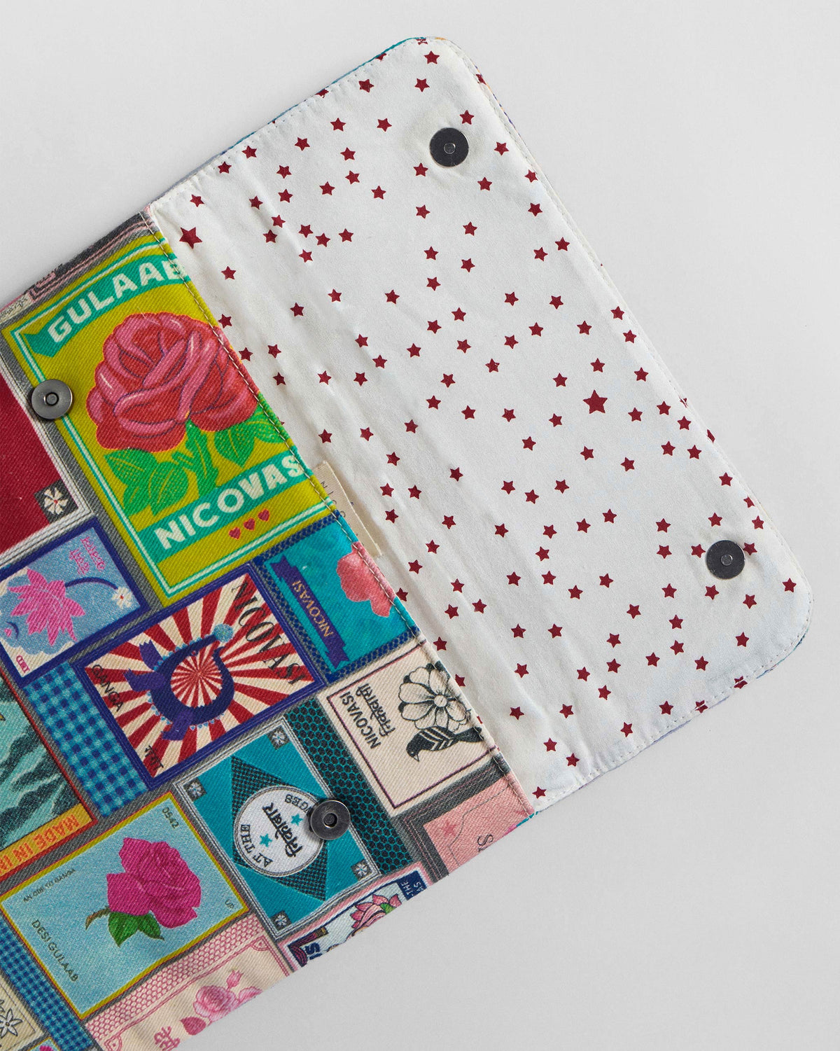 Open Matchbox Laptop Sleeve showing star lining and rose print.