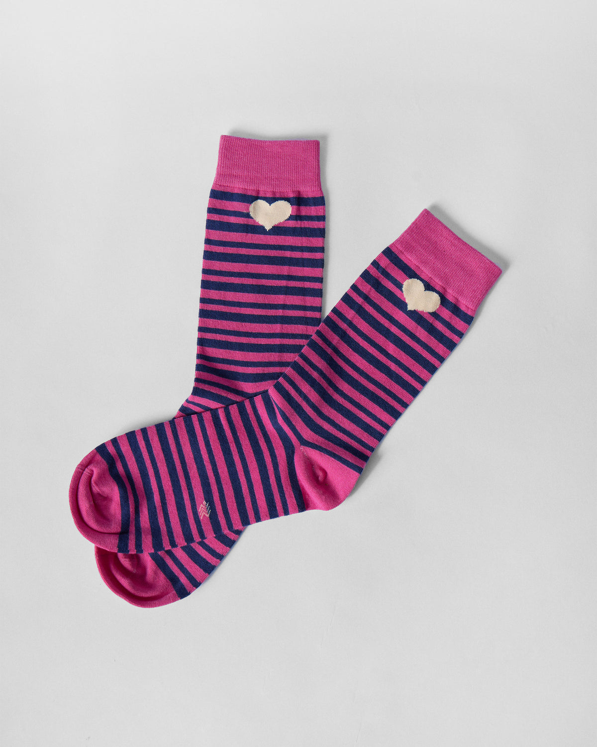 Thick & Thin socks laid flat at an angle, showing pink and navy stripes.