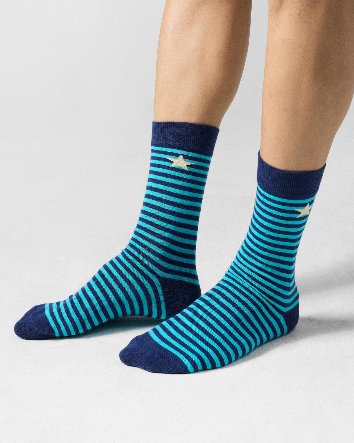 Navy and teal Men's Stride Socks with cream stars at the cuff.