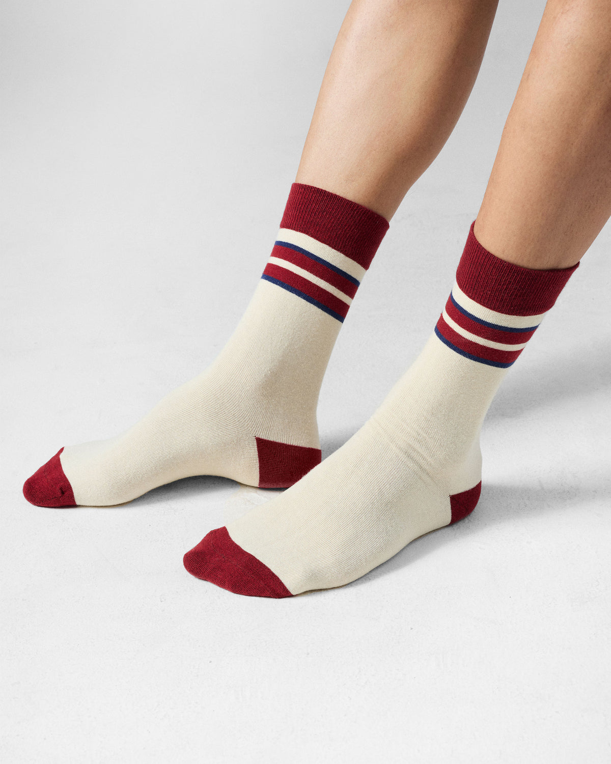 Cream Men's Orbit Socks with maroon cuffs, heels, and toes.