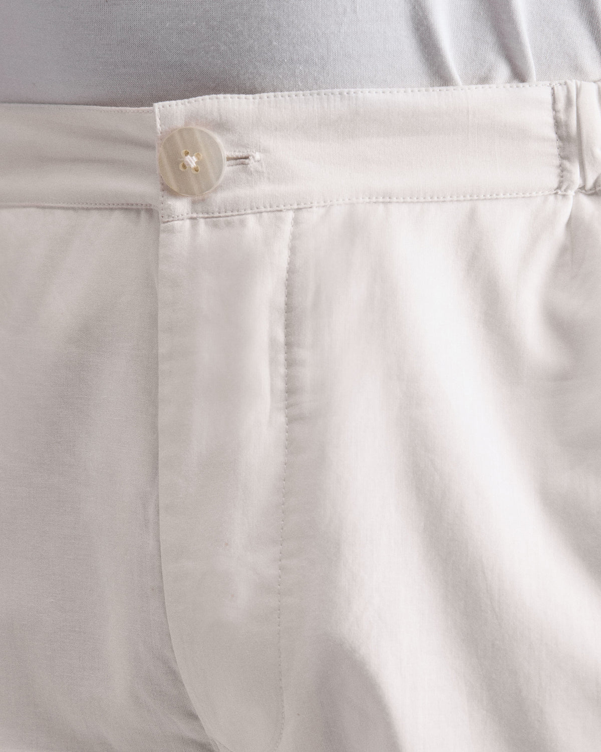 Close-up of ivory Shillong jammies showing the button waistband.