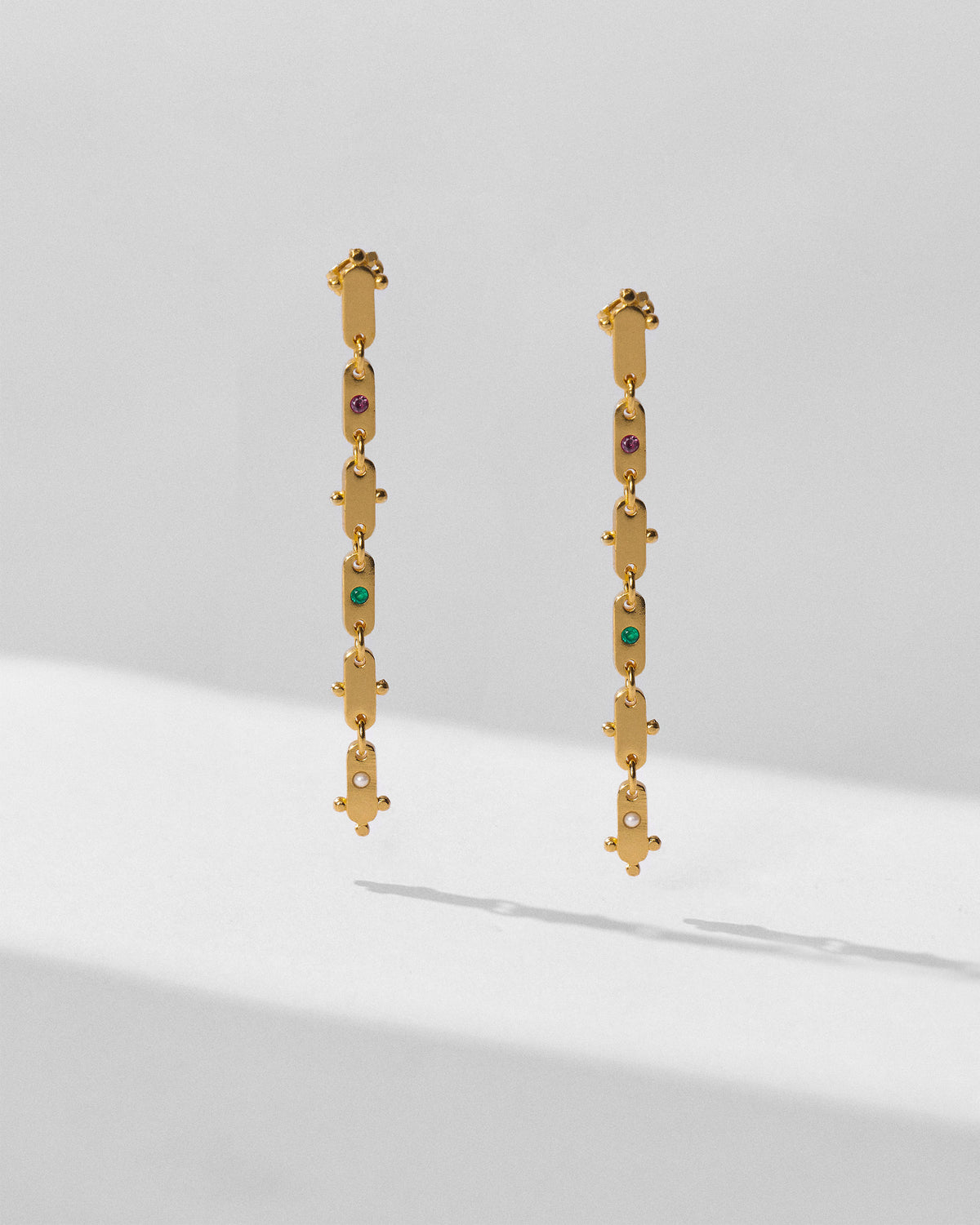 Pair of long gold Ladder earrings showing linked plates.