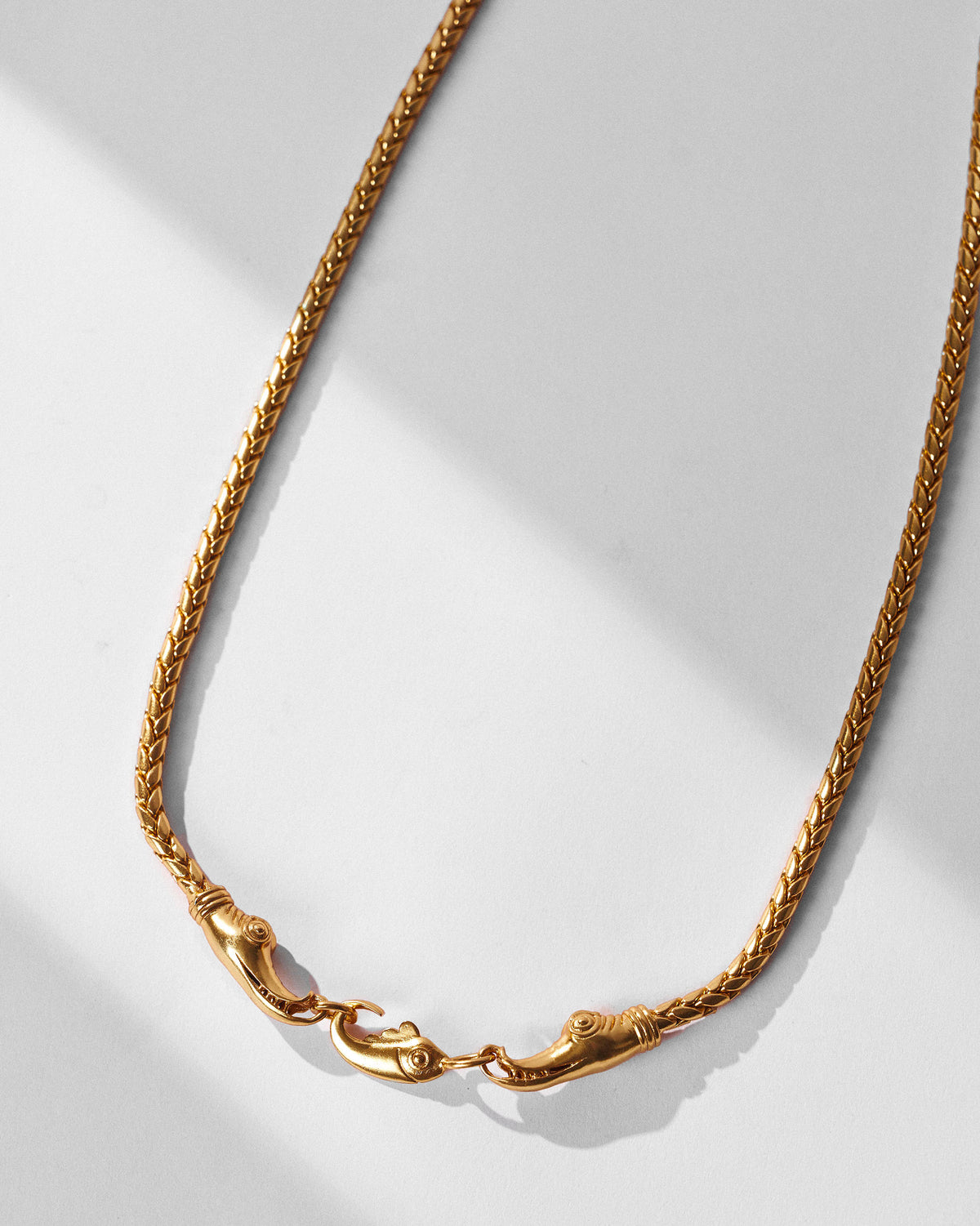Close-up of the gold Makkar chain clasp with makara heads and fish link.