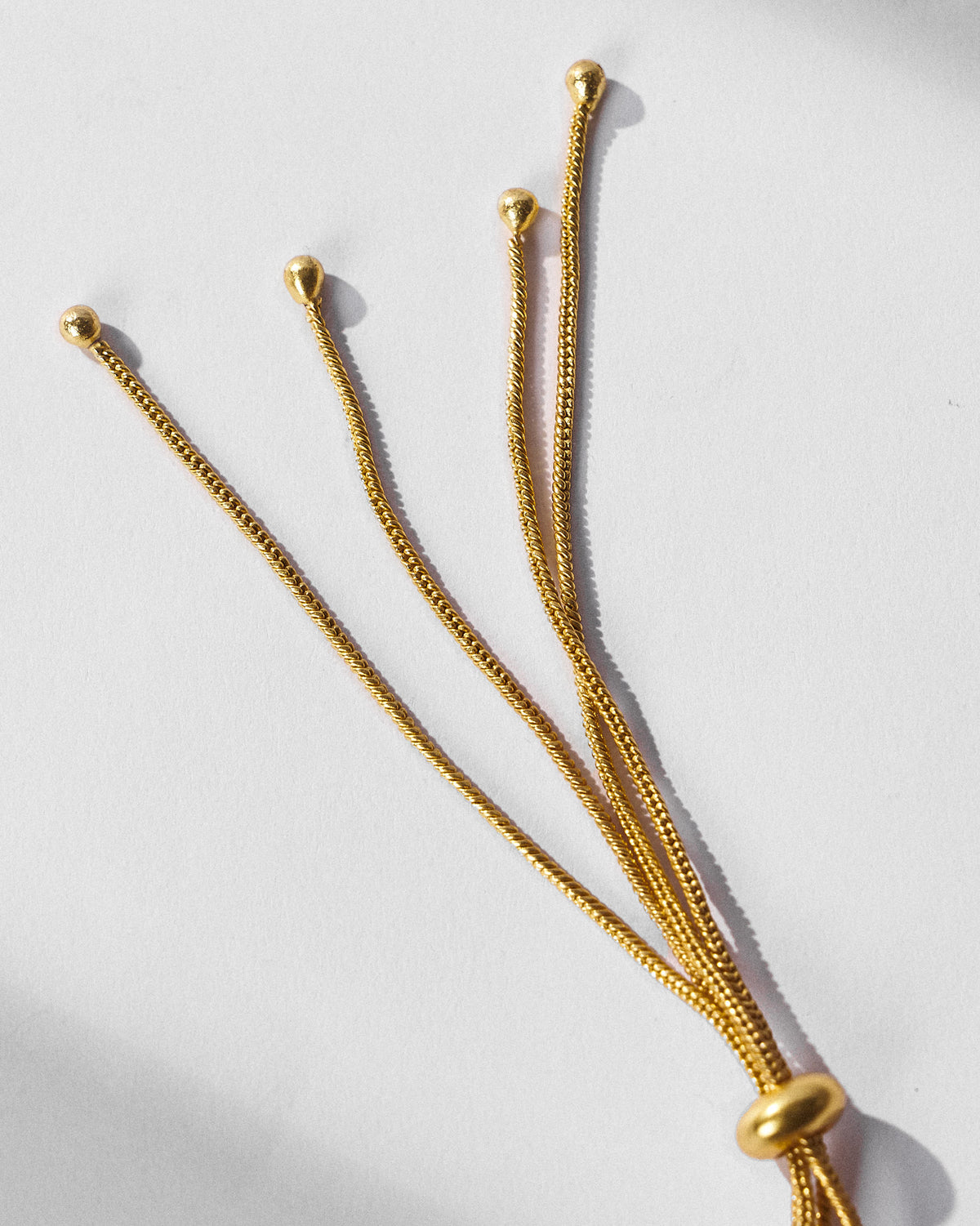 Close-up of the adjustable gold slider clasp on an Ambi choker.