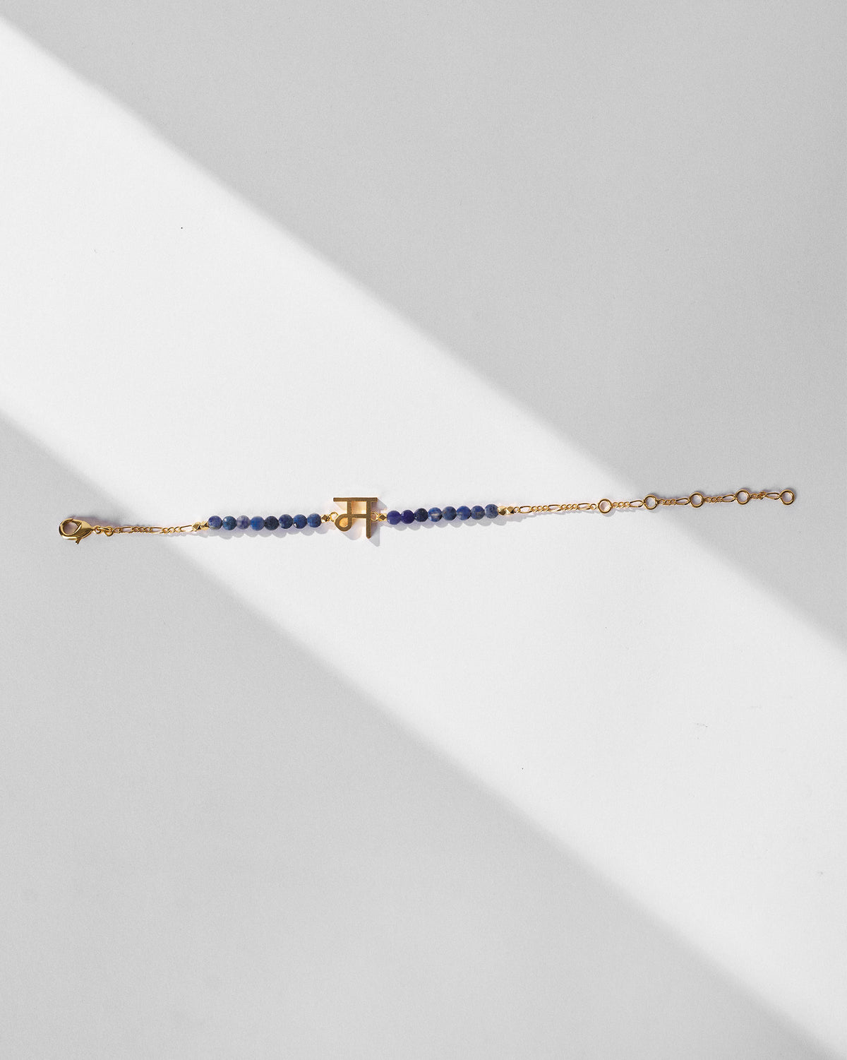 Akshar Bracelet (M) - Gold with its clasp and extension chain visible.