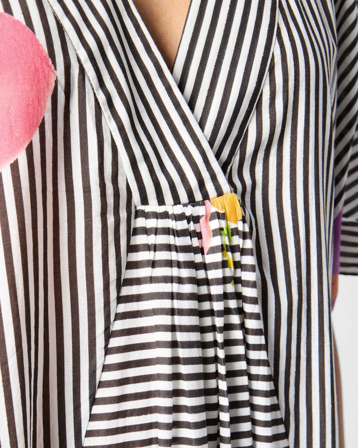 Close-up of the Noa kaftan V-neck with gathered stripes.