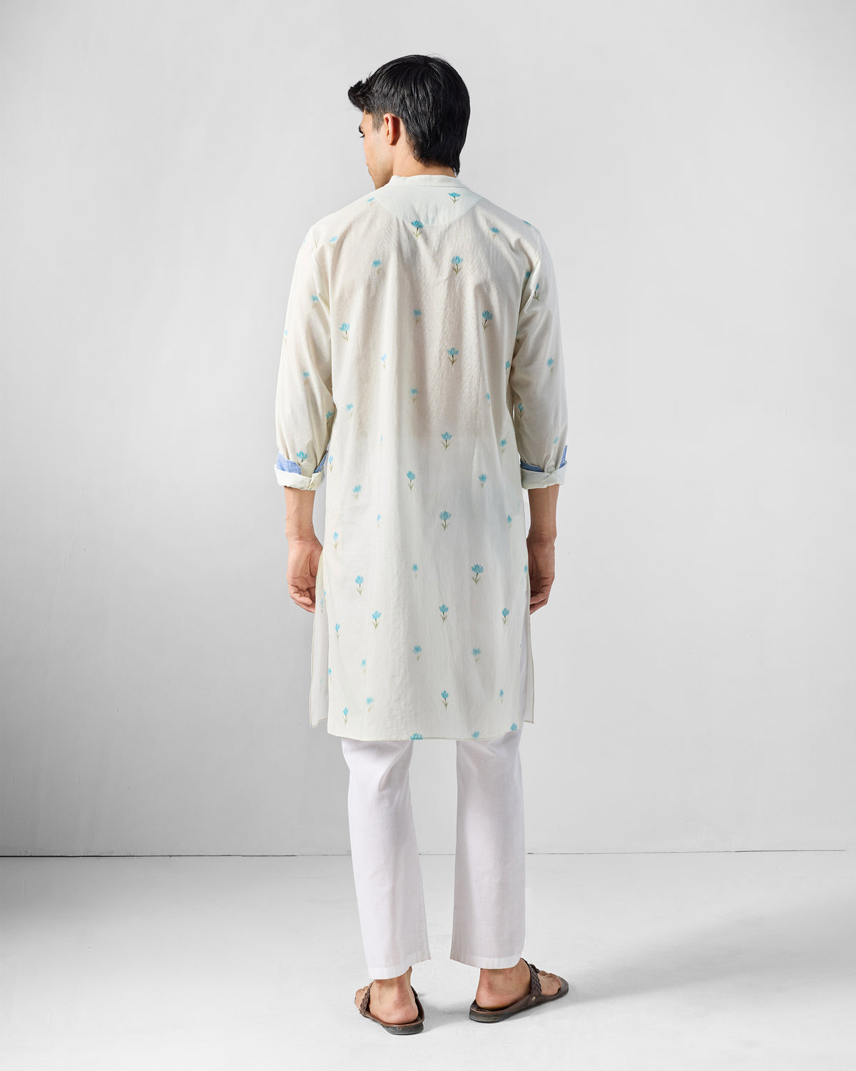 Back of an ivory Astral kurta with a light blue lotus print.