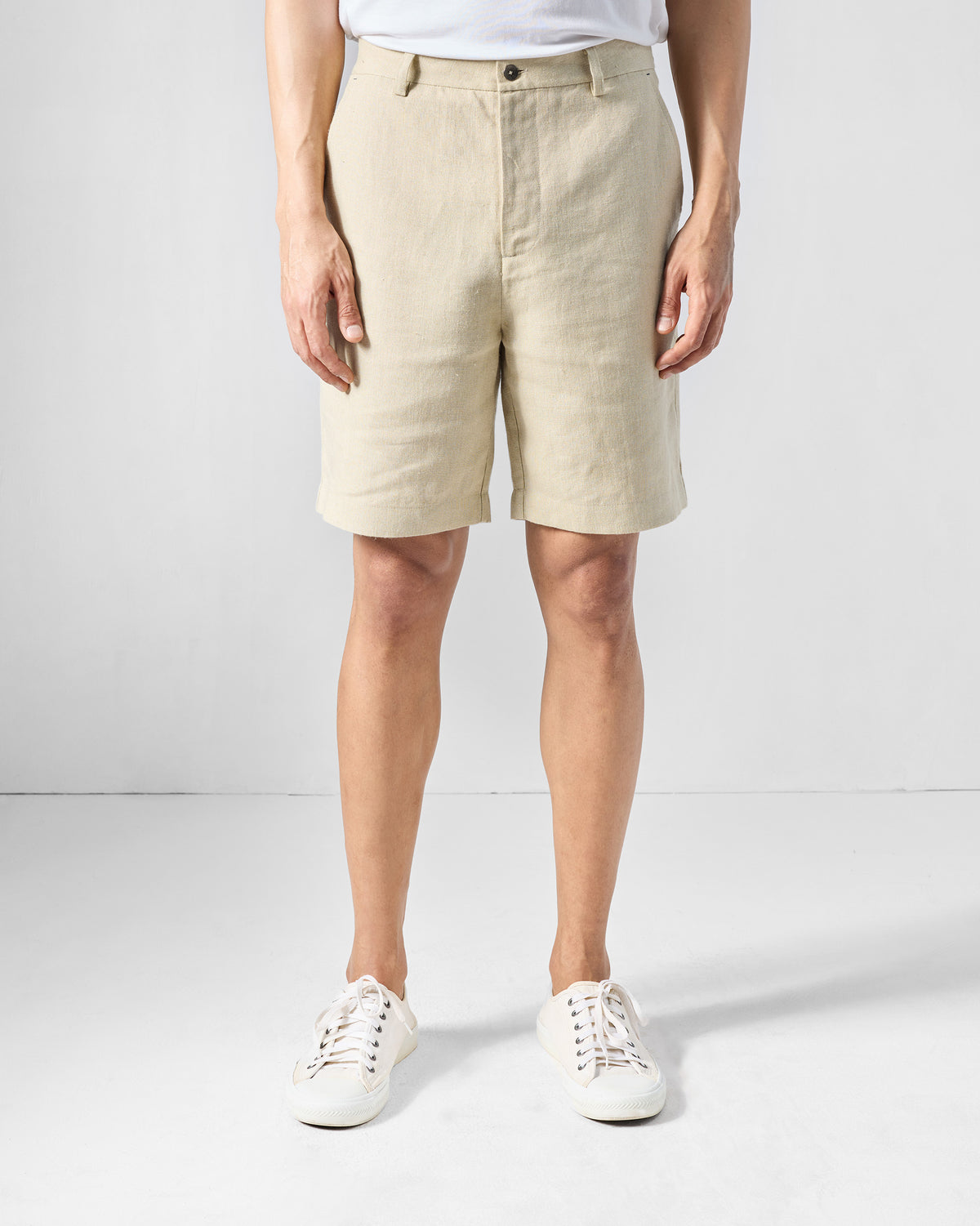 Person wearing natural Coast Shorts with a flat front waistband.