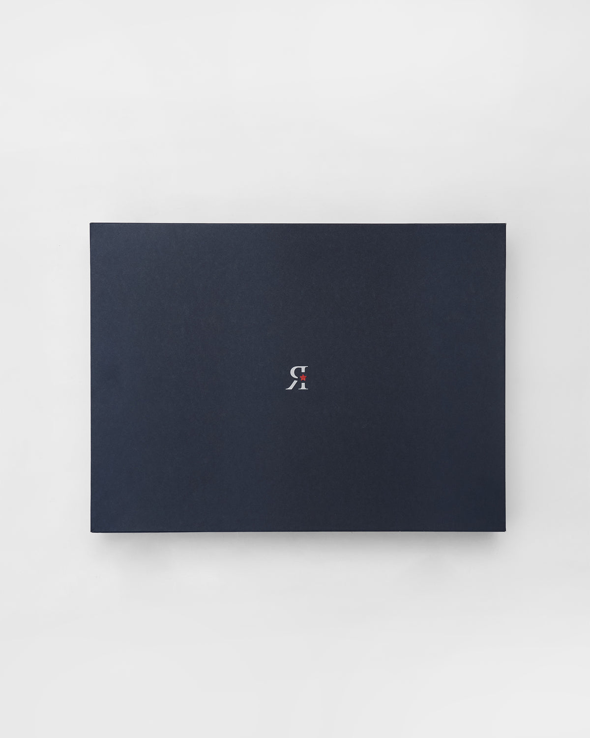 Navy Chandramallika gift box with a small white monogram logo.