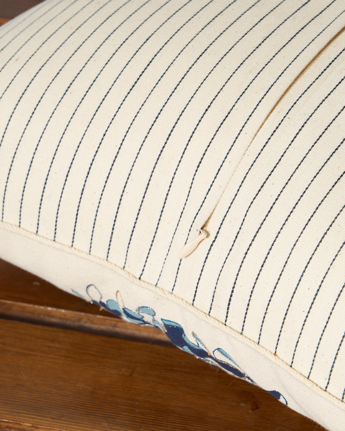 Close-up of the Sevanthi cushion zipper on its striped reverse.