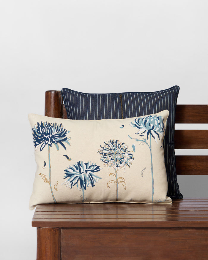 Guldaudi printed lumbar cushion with blue flowers on a cream cover.