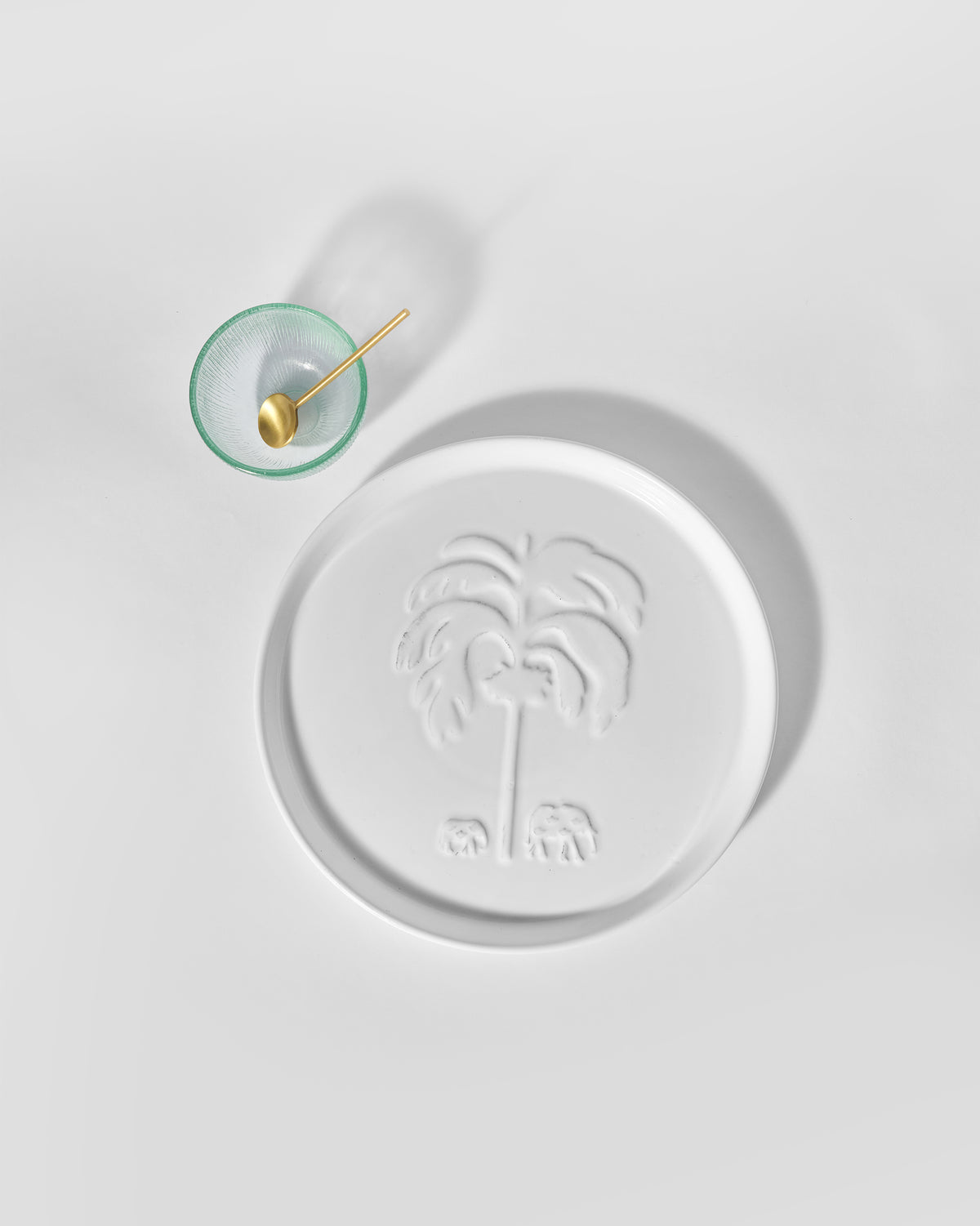 Ele Palm Chip & Dip Platter in white, with a glass bowl and gold spoon beside it.