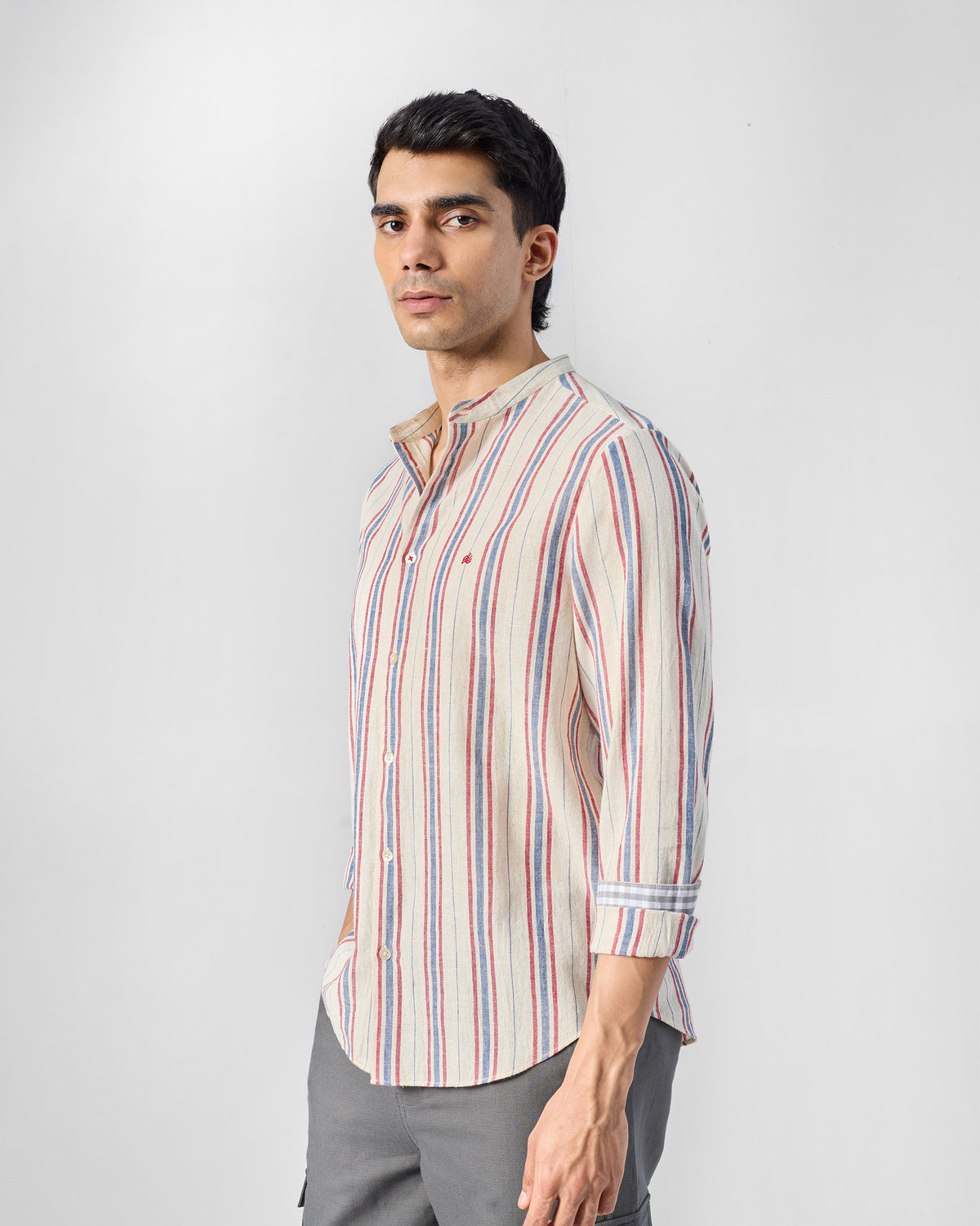 Nawab Shirt three-quarter front in ivory red and blue stripes.