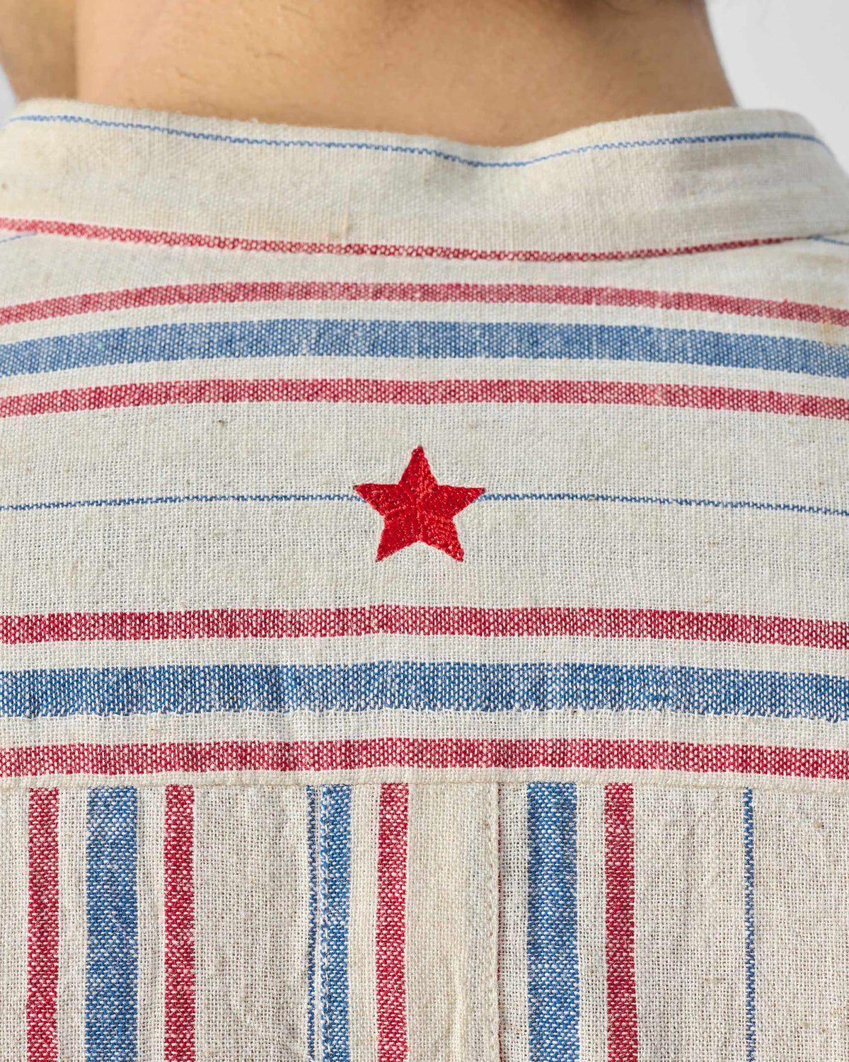 Close-up of Nawab Shirt back yoke with horizontal stripes and red star.