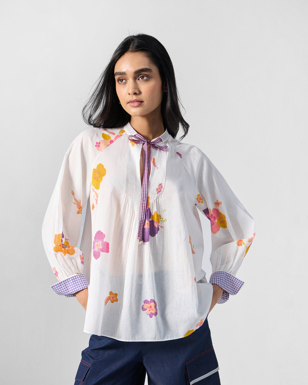 Flutter Blouse front in ivory with pink florals and a purple check tie.