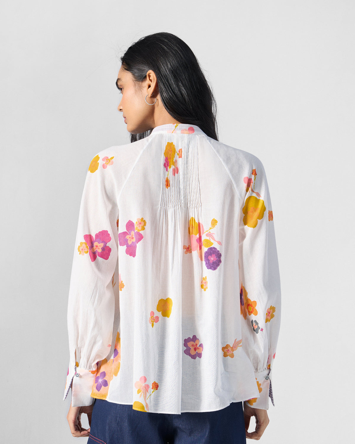 Back of a Flutter Blouse in ivory with pink florals and center pintucks.