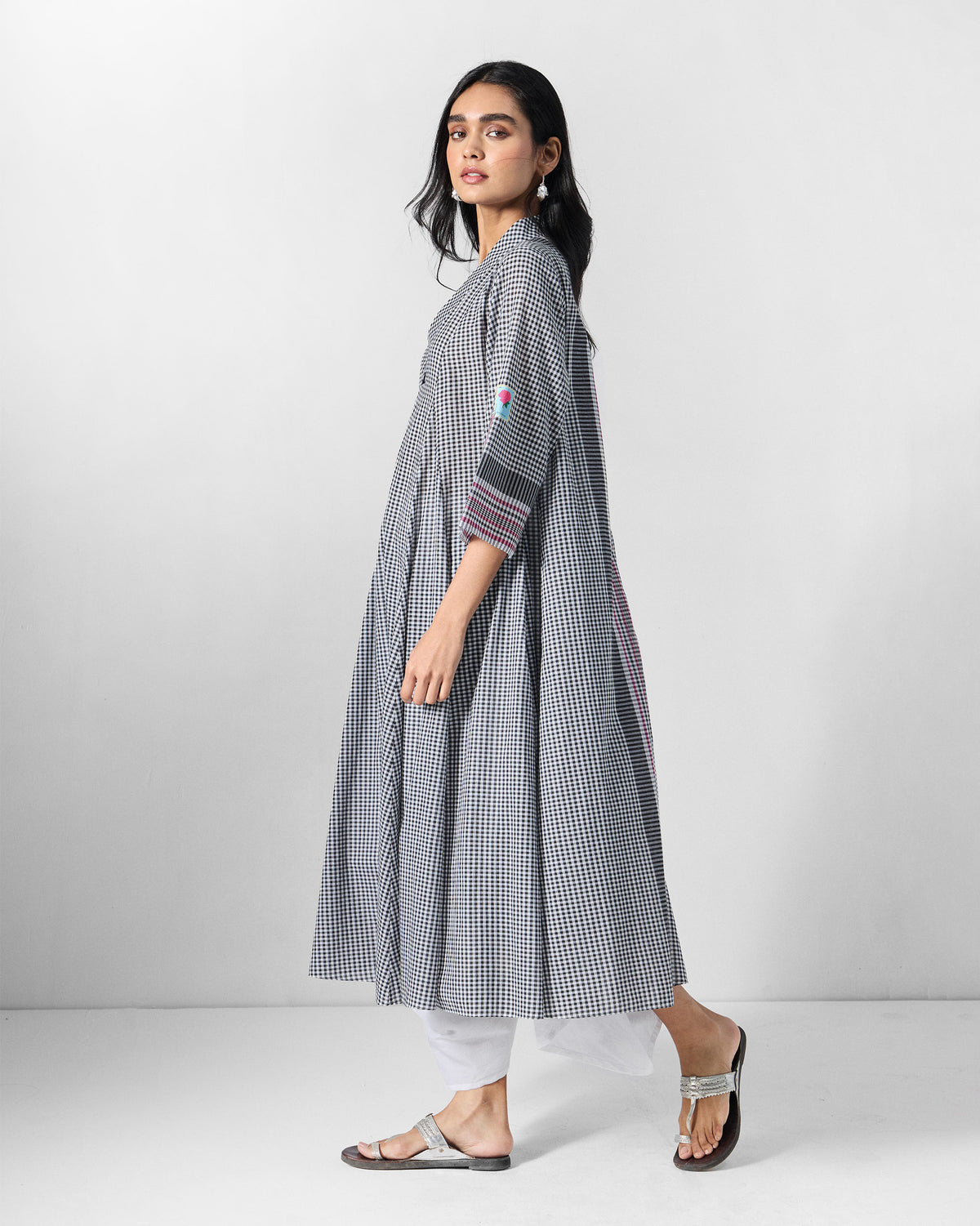 Person wearing a black and white checked Leah kurta with a flared A-line shape.