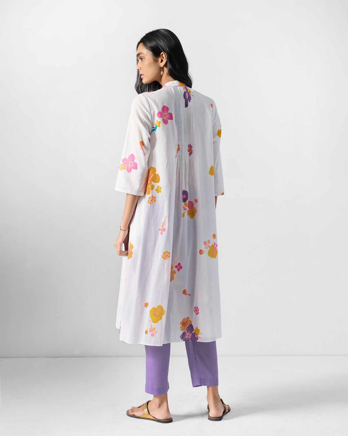 Back of an ivory Mirage kurta with a centre back pleat.