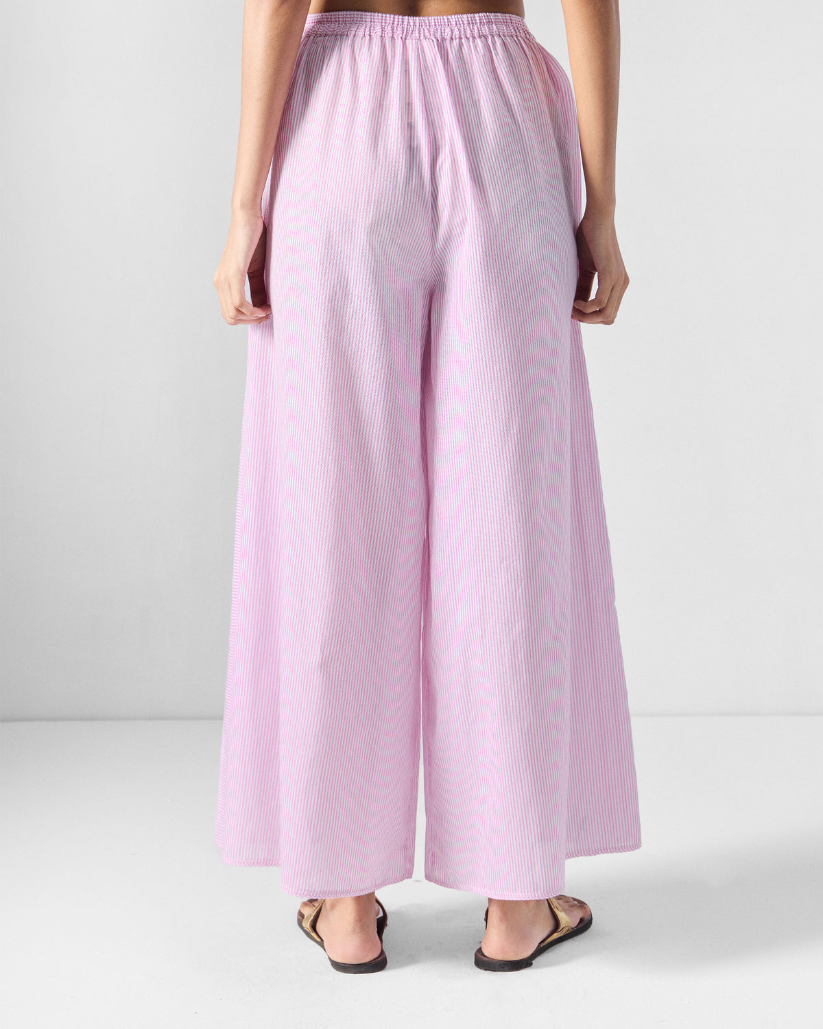 Back of pink and white striped Ceylon pants with a gathered elastic waist.