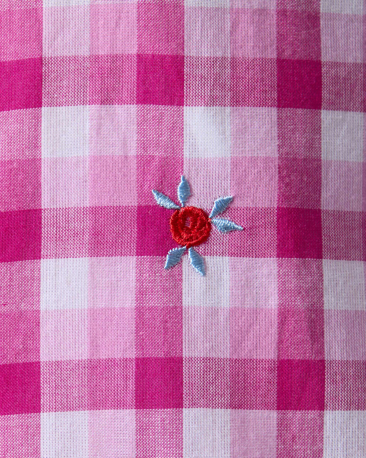 Close-up of sequin embroidery on a pink and white check Amaya tunic.