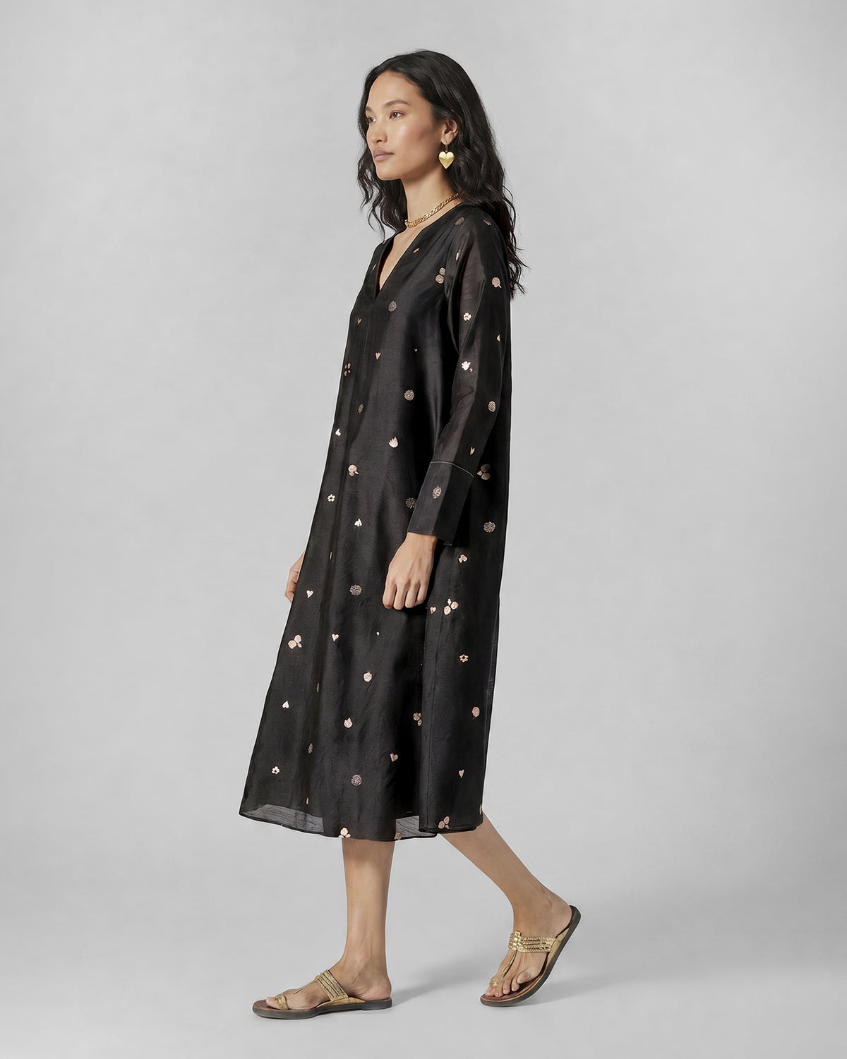 Side view of a black and pink printed V-Neck Flared dress.