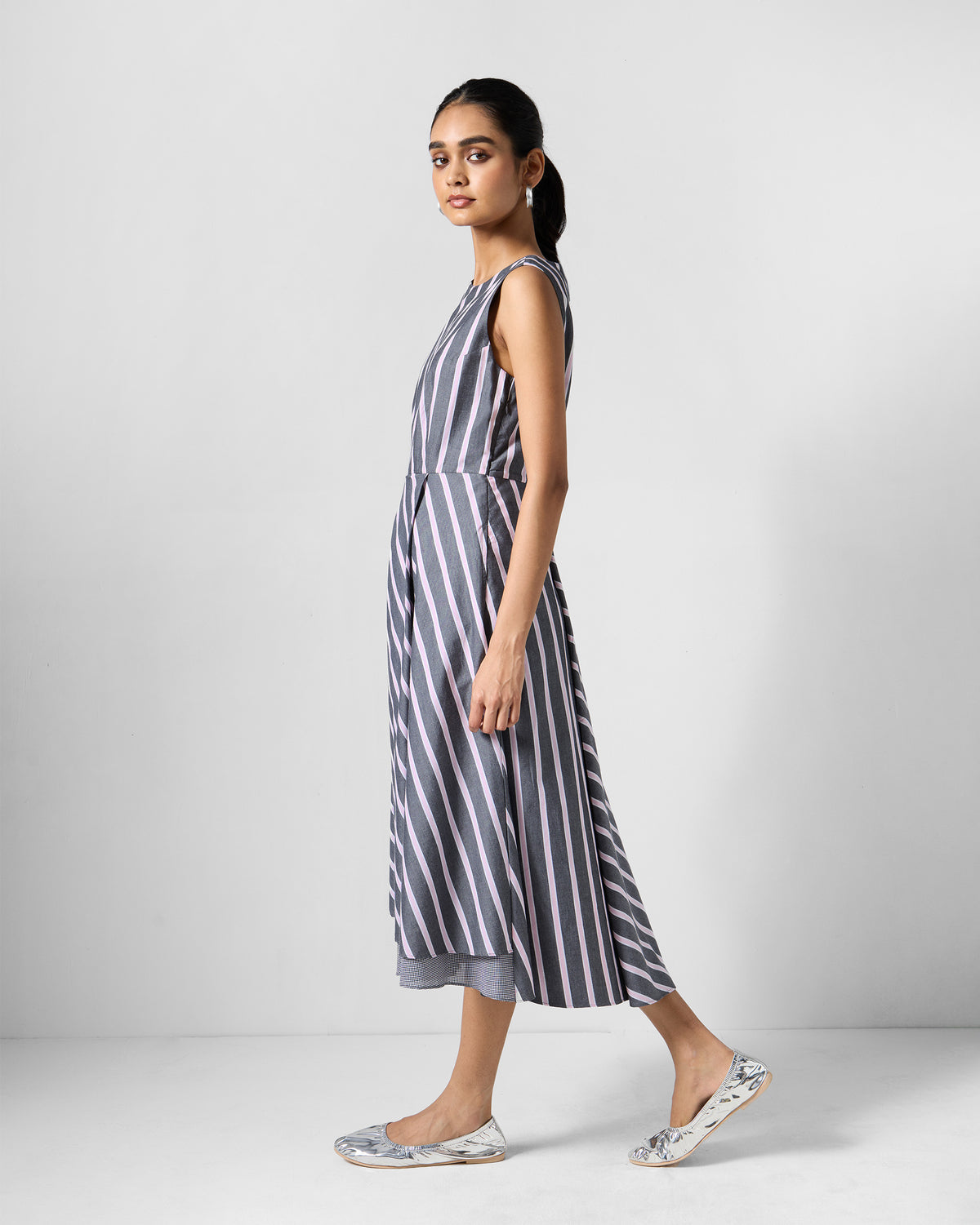 Side view of a charcoal and pink striped Tapas layered dress.