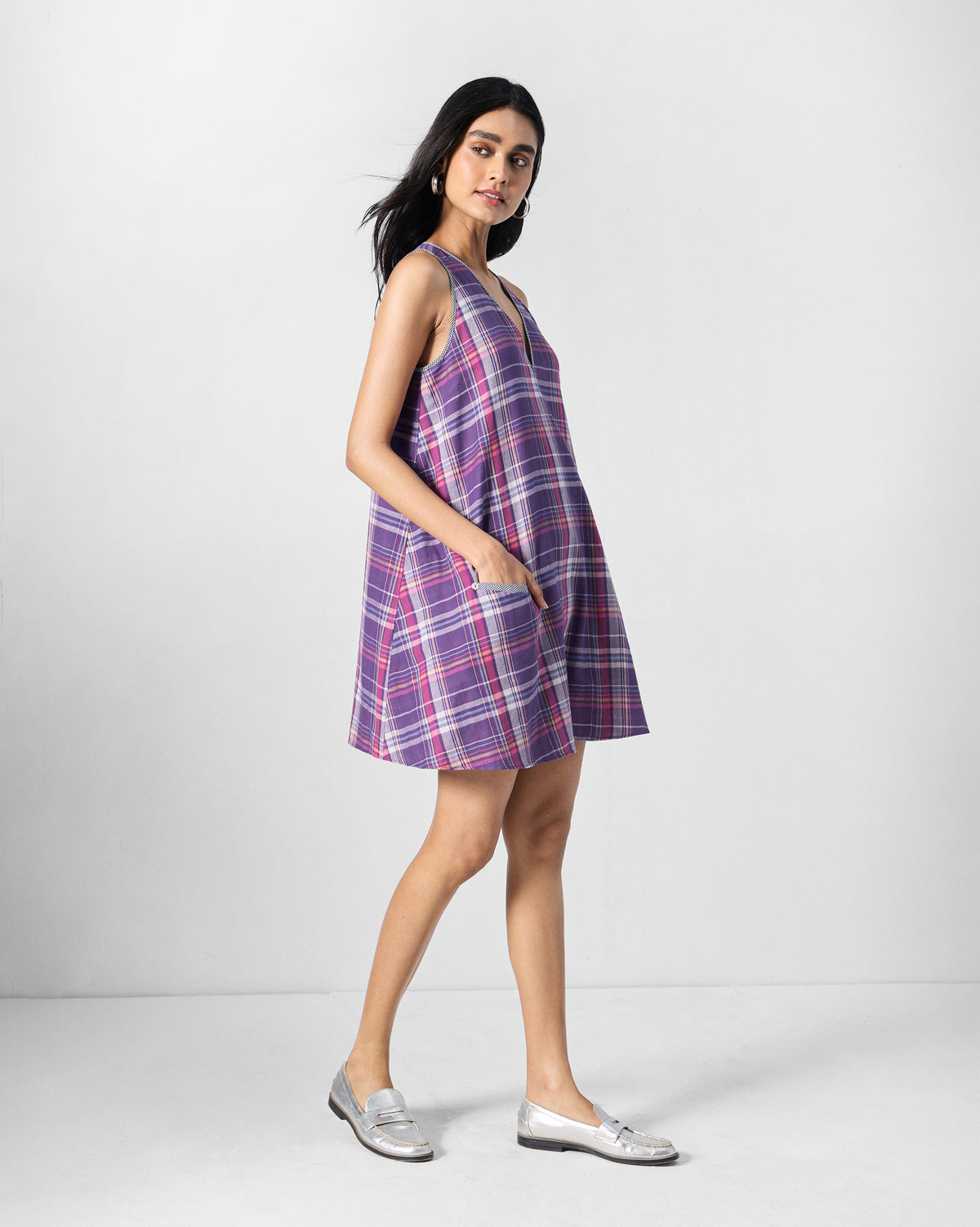 Side view of a purple check Daye dress showing a pocket.
