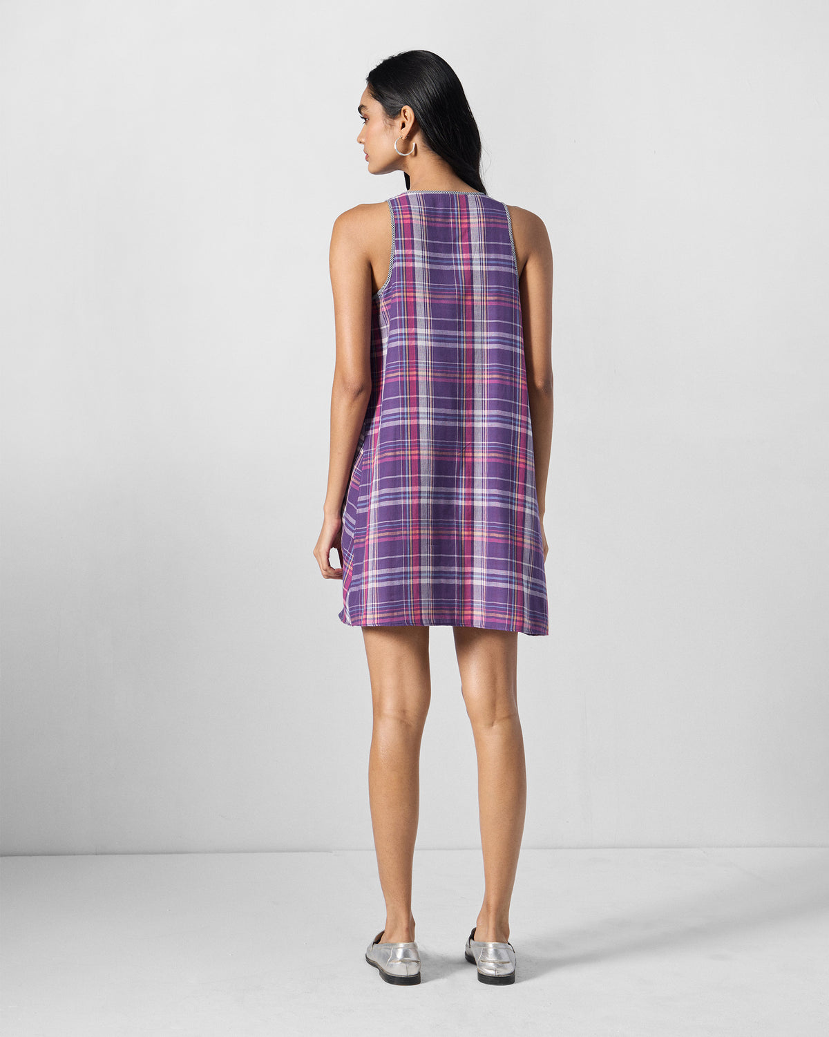 Back of a sleeveless purple check Daye dress on a person.