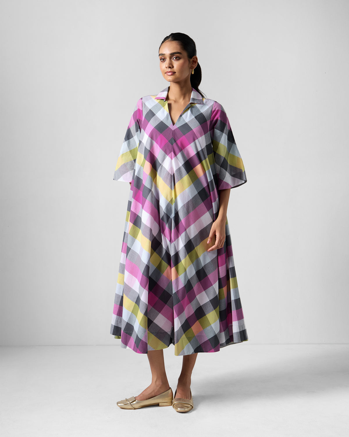 Person wearing a multicolour check Areva A-Line Dress with a shirt collar.