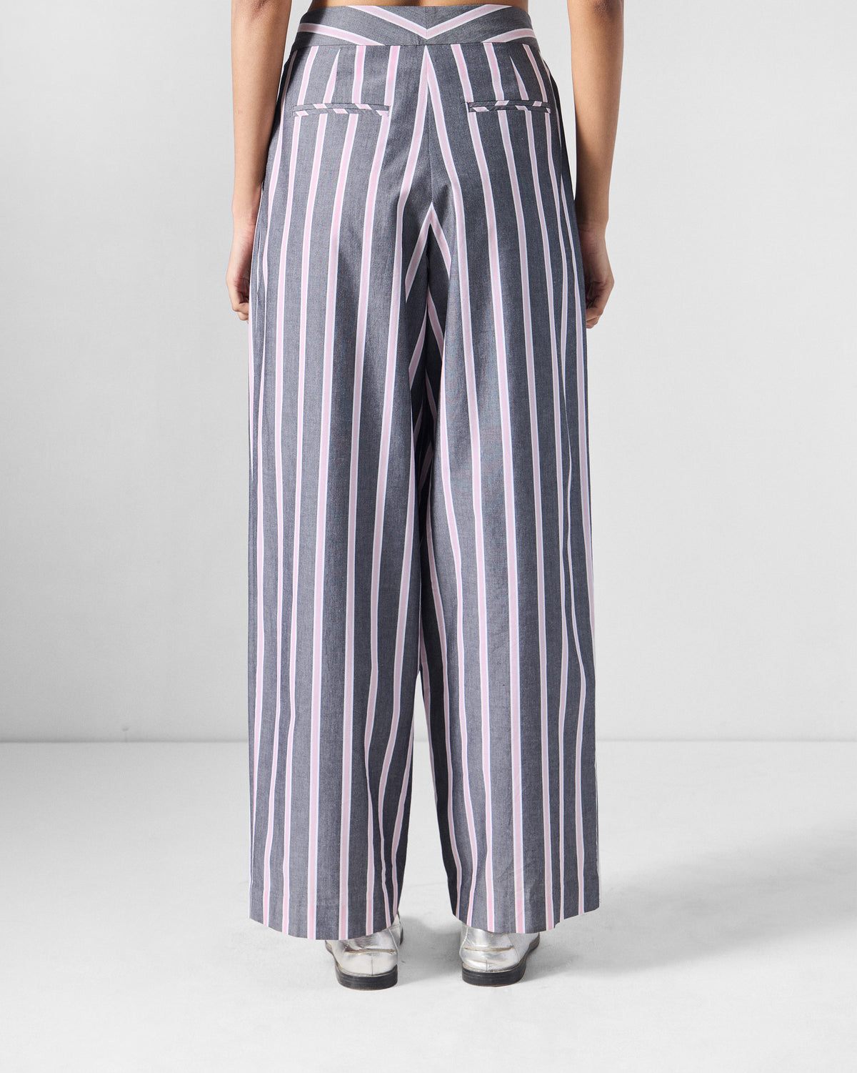 Back of charcoal and pink striped Row pants with a chevron waistband.