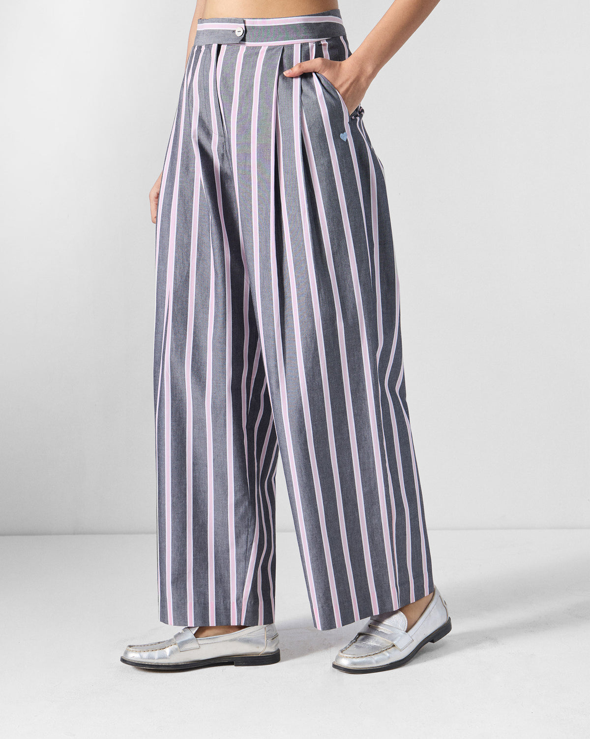 Side view of charcoal and pink striped Row pants with a blue heart near the pocket.