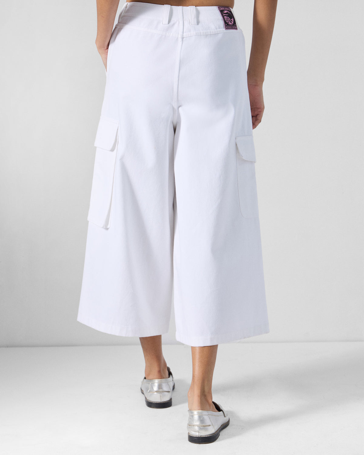 Back of white Ella culottes with wide cropped legs and side cargo pockets.